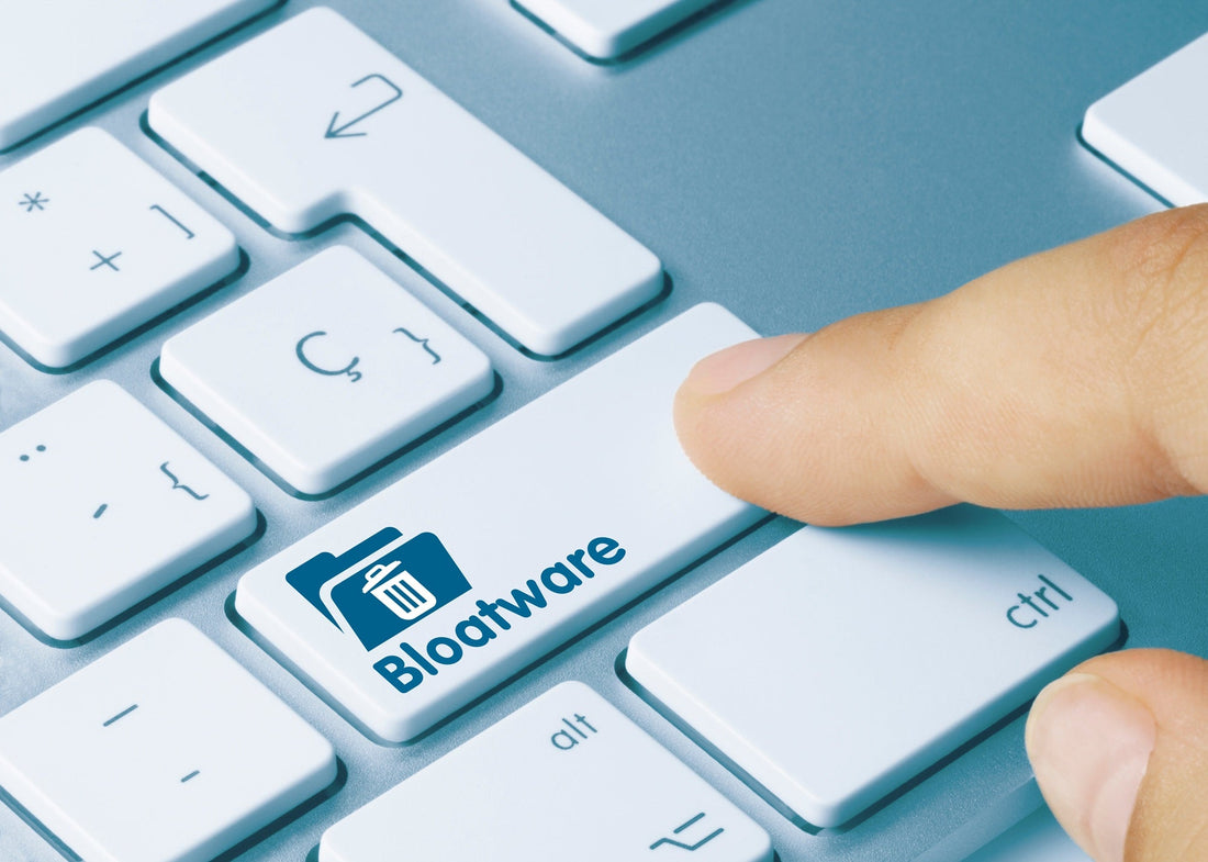How to Remove Windows 11 Bloatware _ finger pressing a remove bloatware key on keyboard for visualization